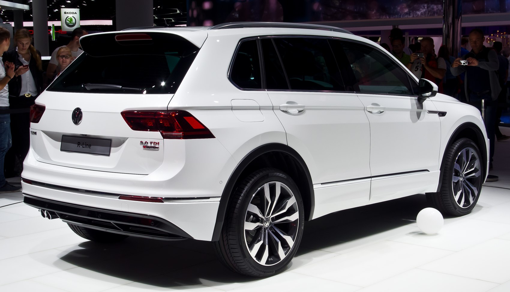 Rear view of white SUV with dual exhaust and alloy wheels