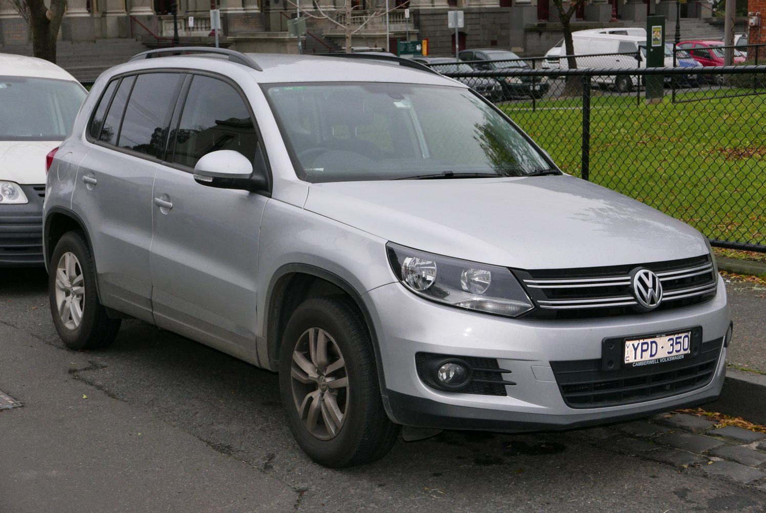 Silver compact SUV front and side view with headlights and grille