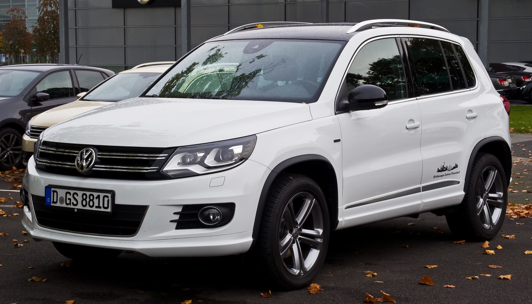 White SUV with front grille, headlights, and alloy wheels