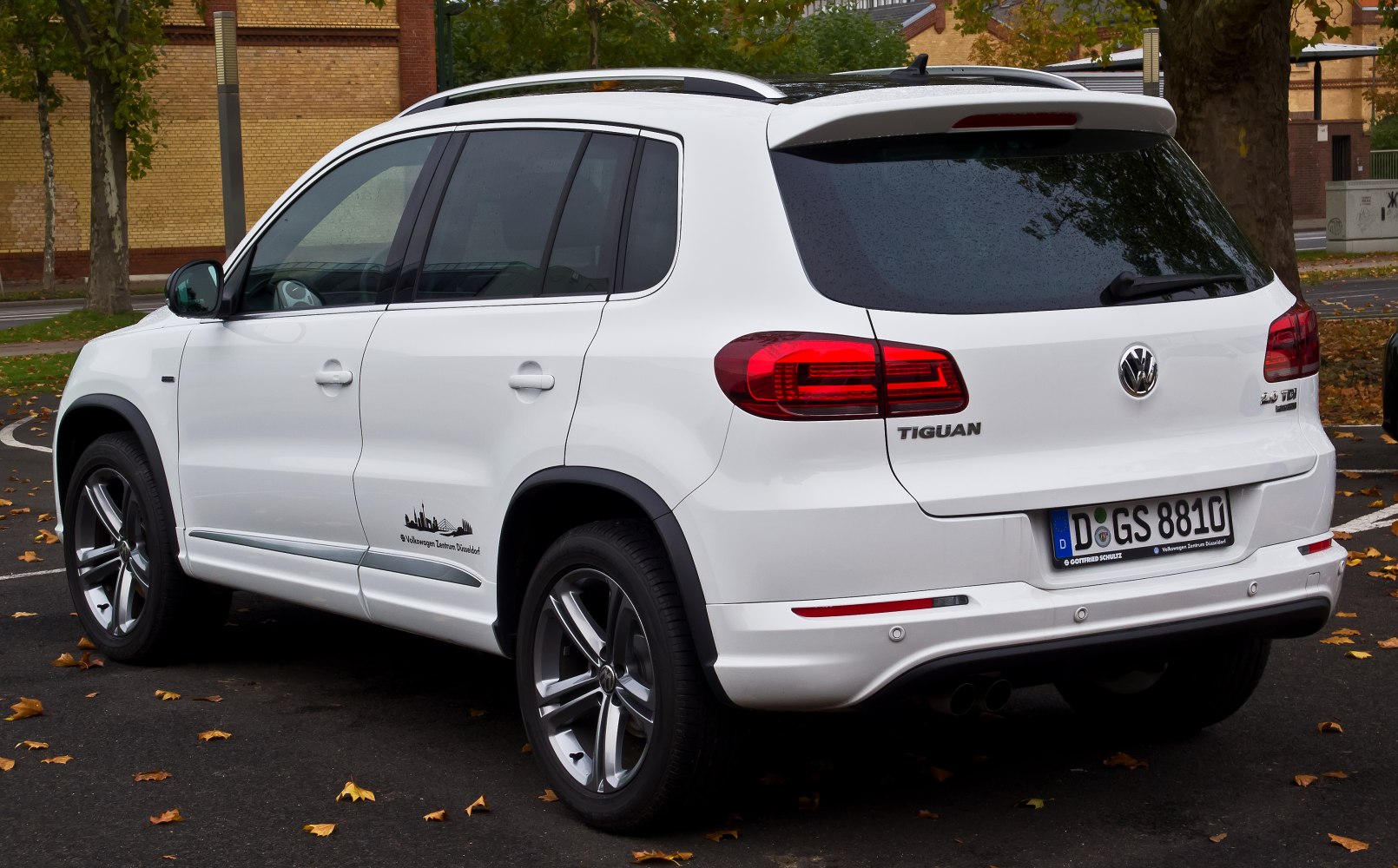 Rear and side profile of a white SUV with modern taillights and alloy wheels