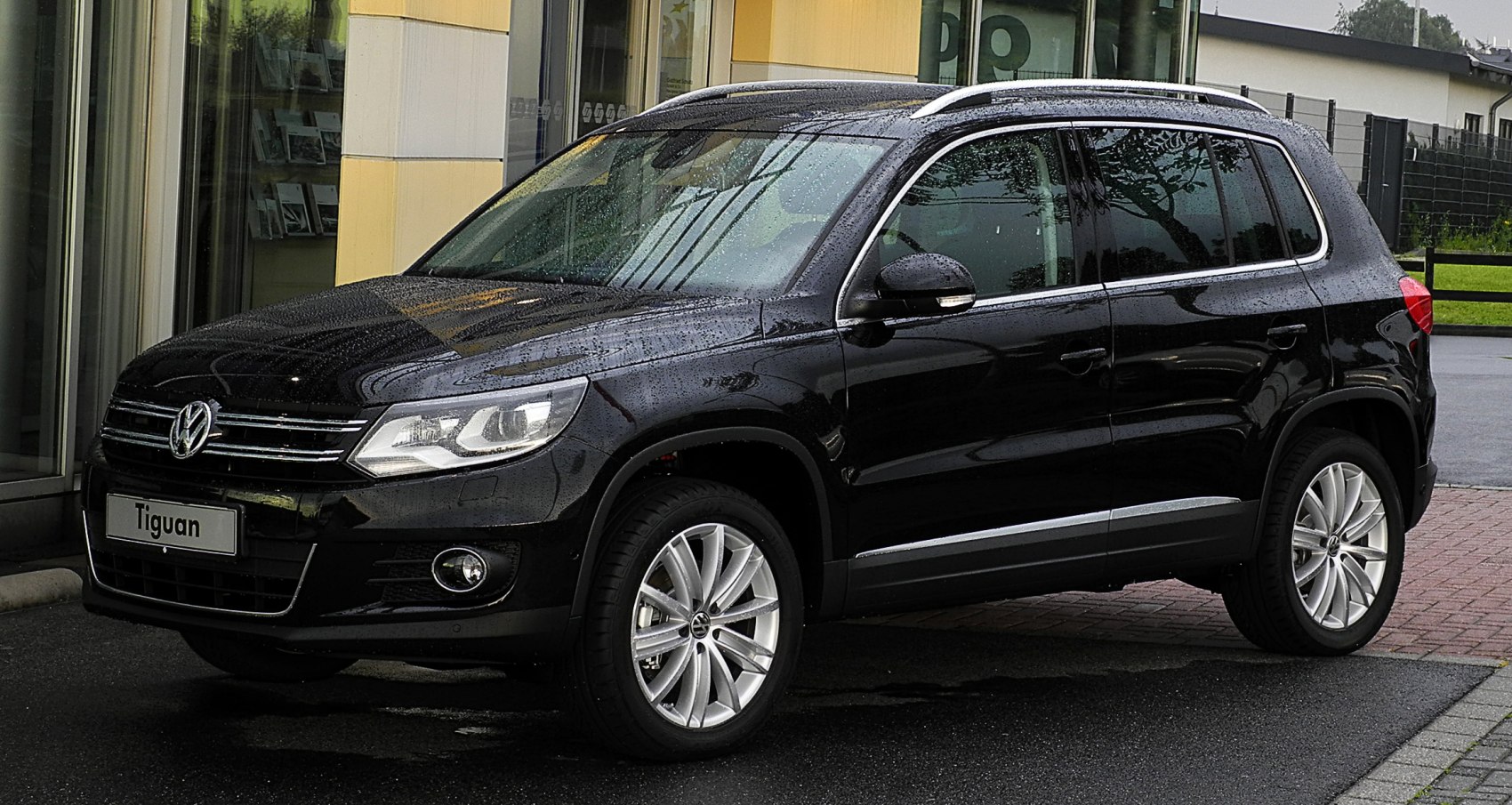 Front-side view of black SUV with alloy wheels and modern headlights