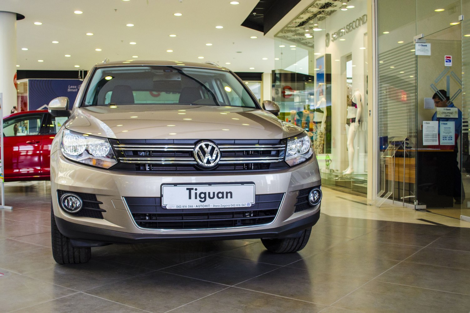 Front view with grille, headlights, and fog lights in showroom