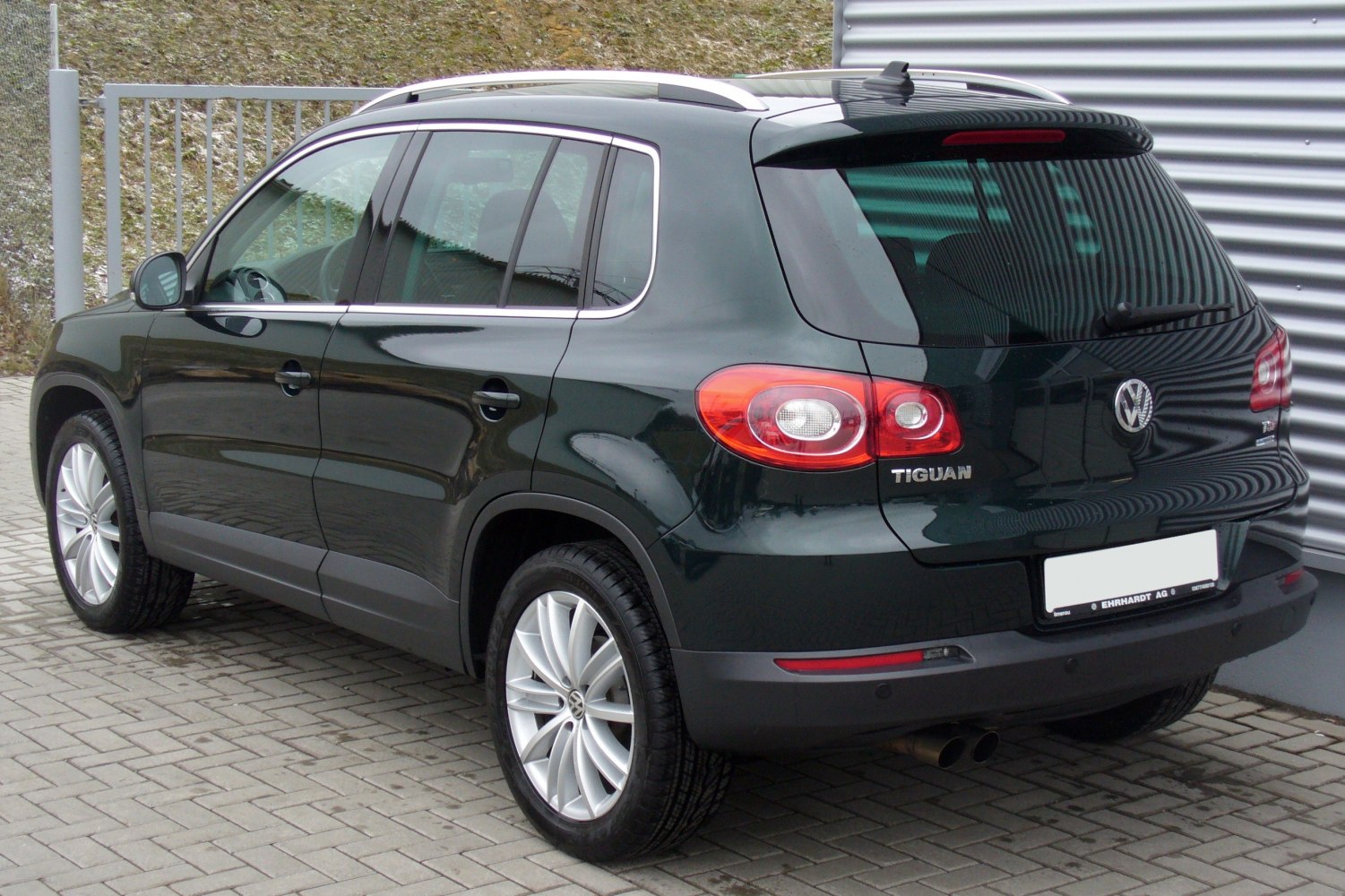 Rear and side profile with taillights, alloy wheels, and tinted rear windows