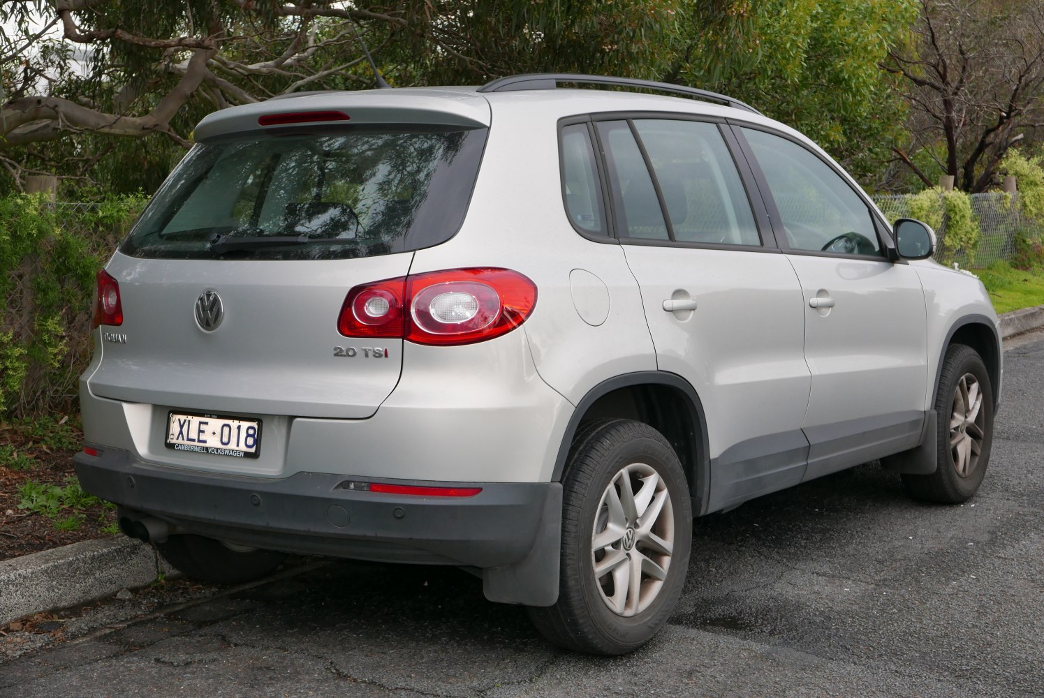 Silver compact SUV rear view with 2.0 TSI badge and roof rails