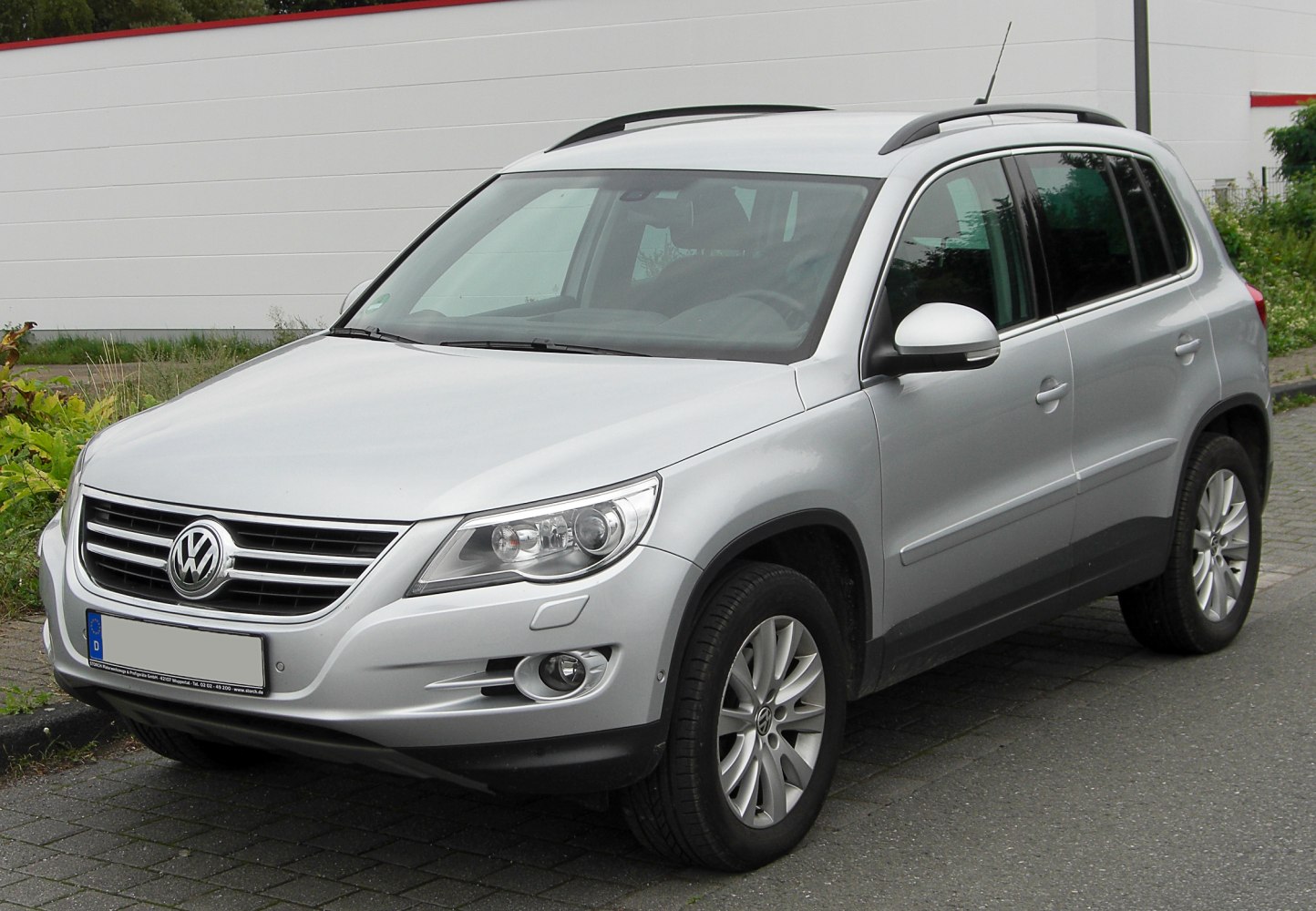 Silver SUV front side view with headlights and roof rails