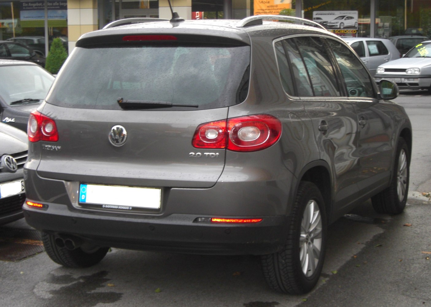 Distinctive rear design with oval tail lights and dual exhaust pipes.