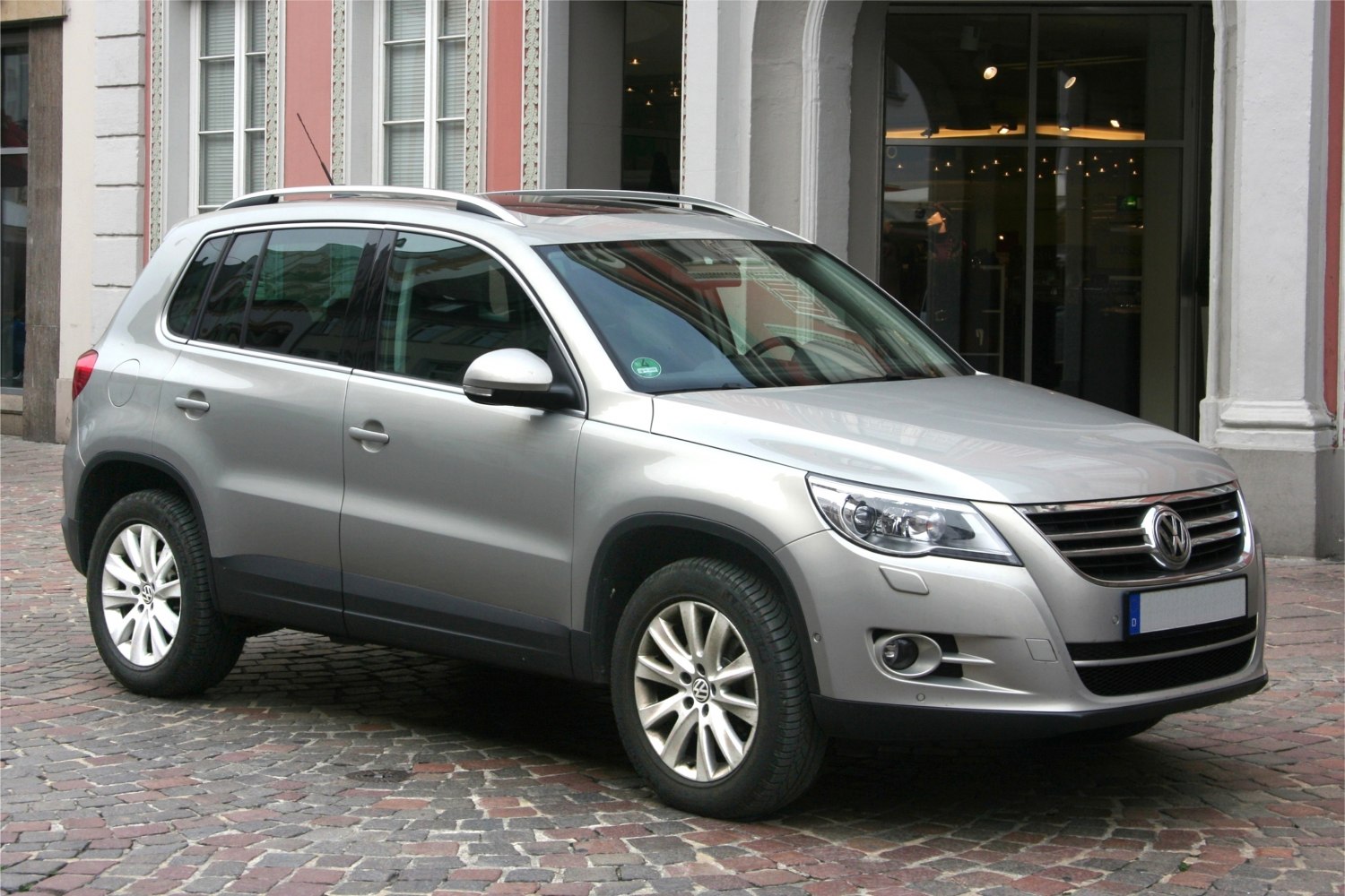 Silver compact SUV with alloy wheels and roof rails front view