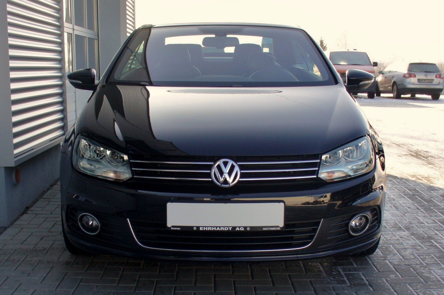 Black car front with headlights and grille close-up