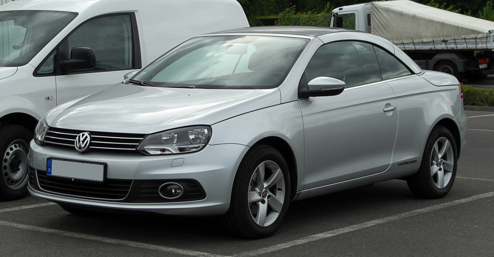 Silver coupe with front-side view including alloy wheels and headlamps