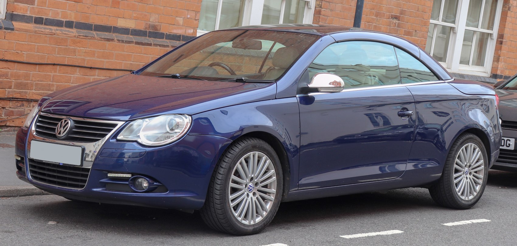 Blue convertible coupe with alloy wheels and aerodynamic design