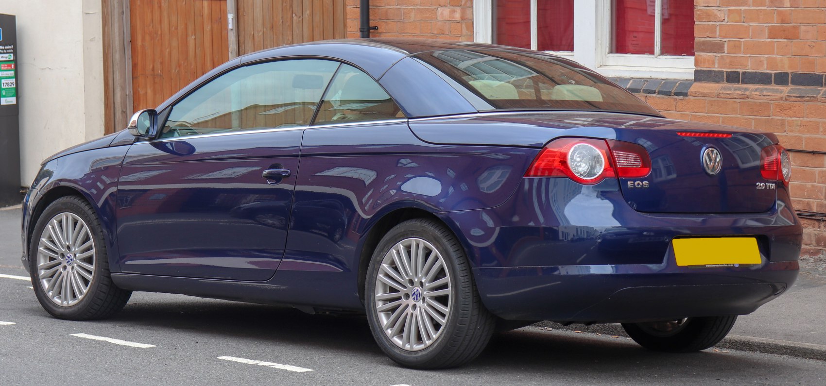 Rear side view of convertible with hardtop and alloy wheels