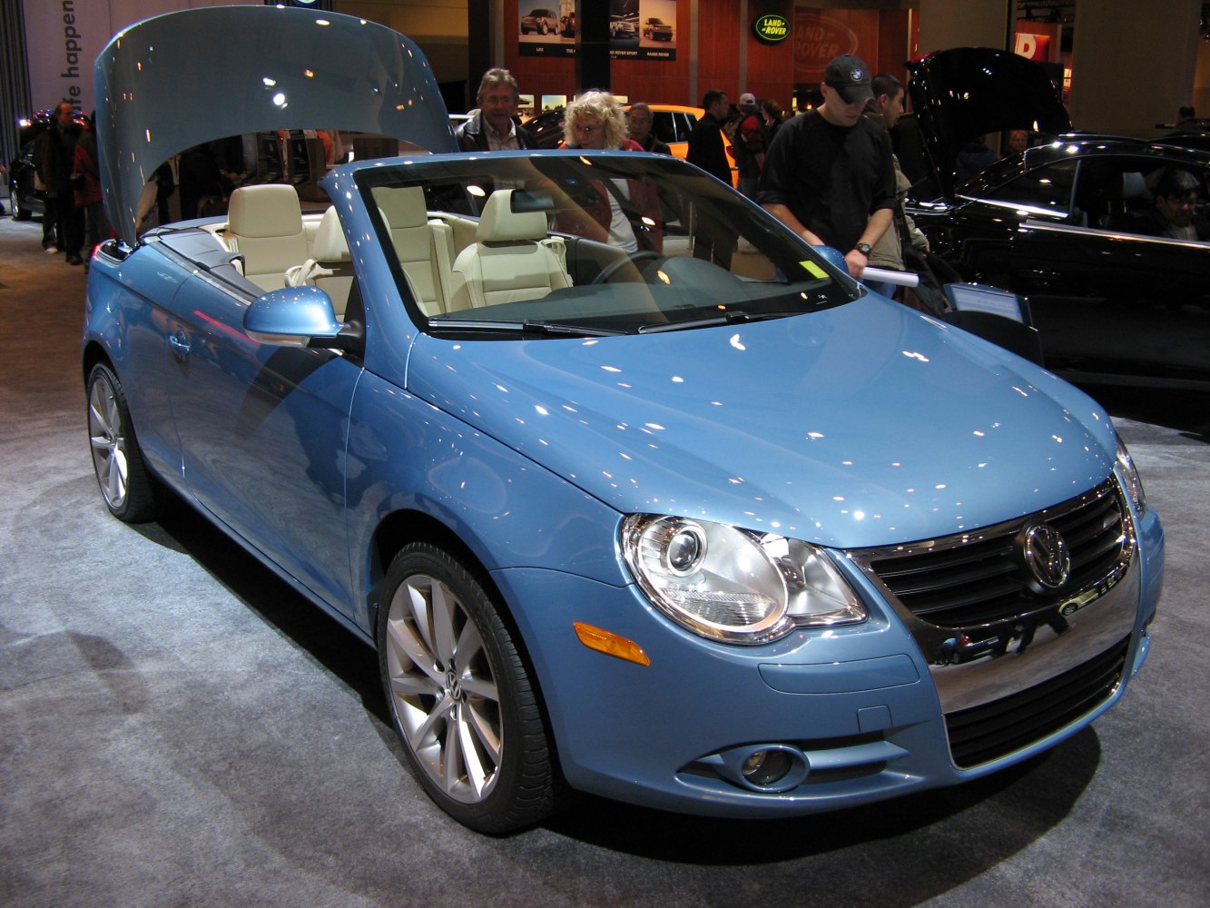 Front view of a sky blue convertible with open roof and alloy wheels