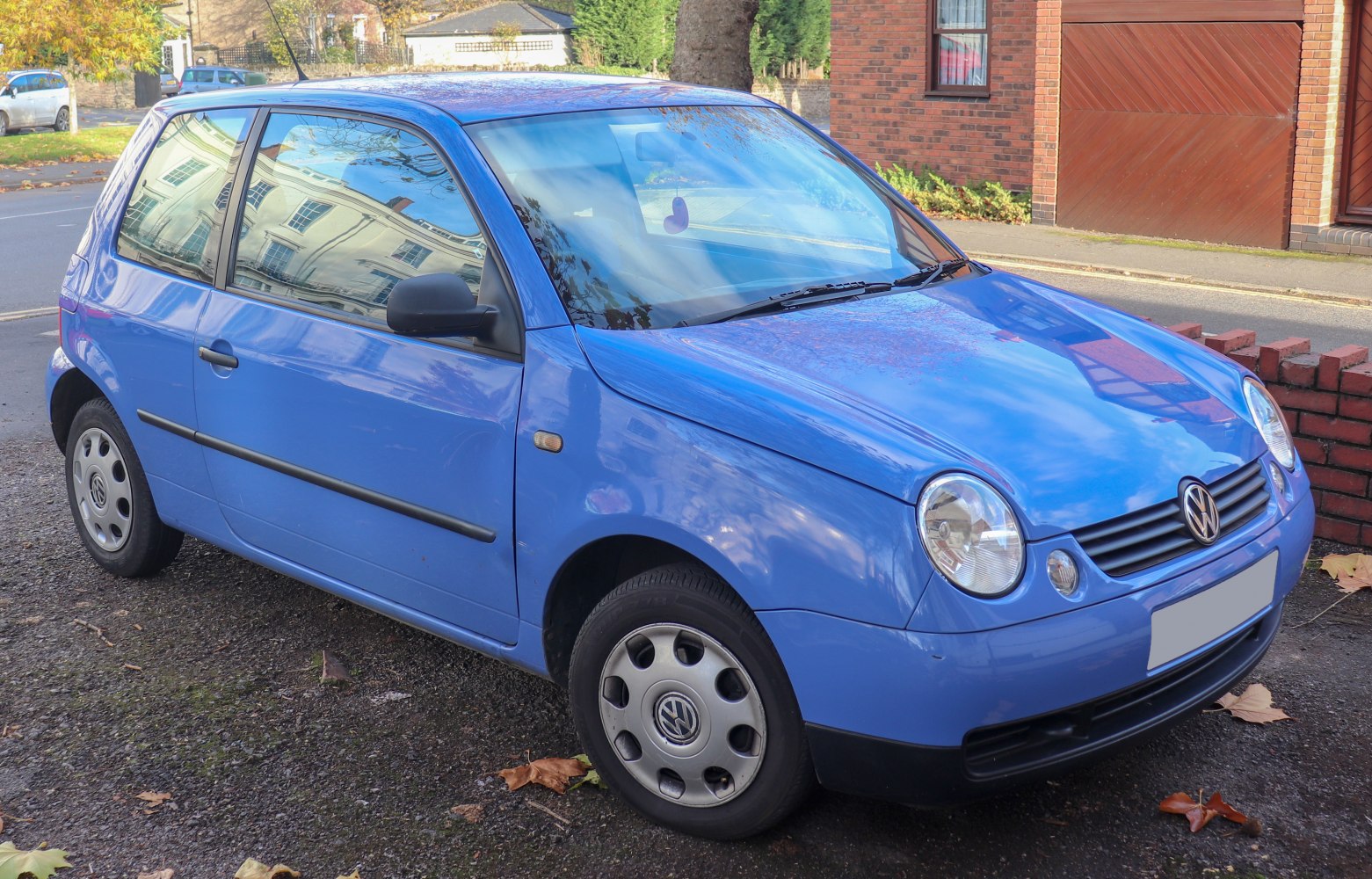 Blue 3-door hatchback with round headlights and compact design.