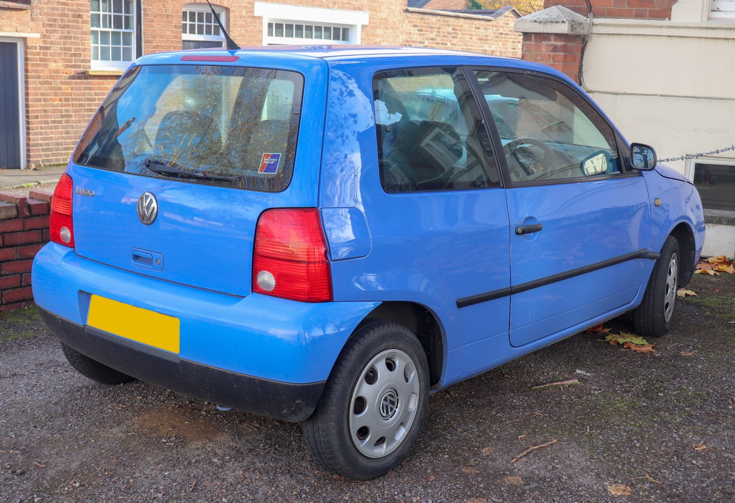 Rear side view of a compact hatchback with rounded edges and distinct taillights
