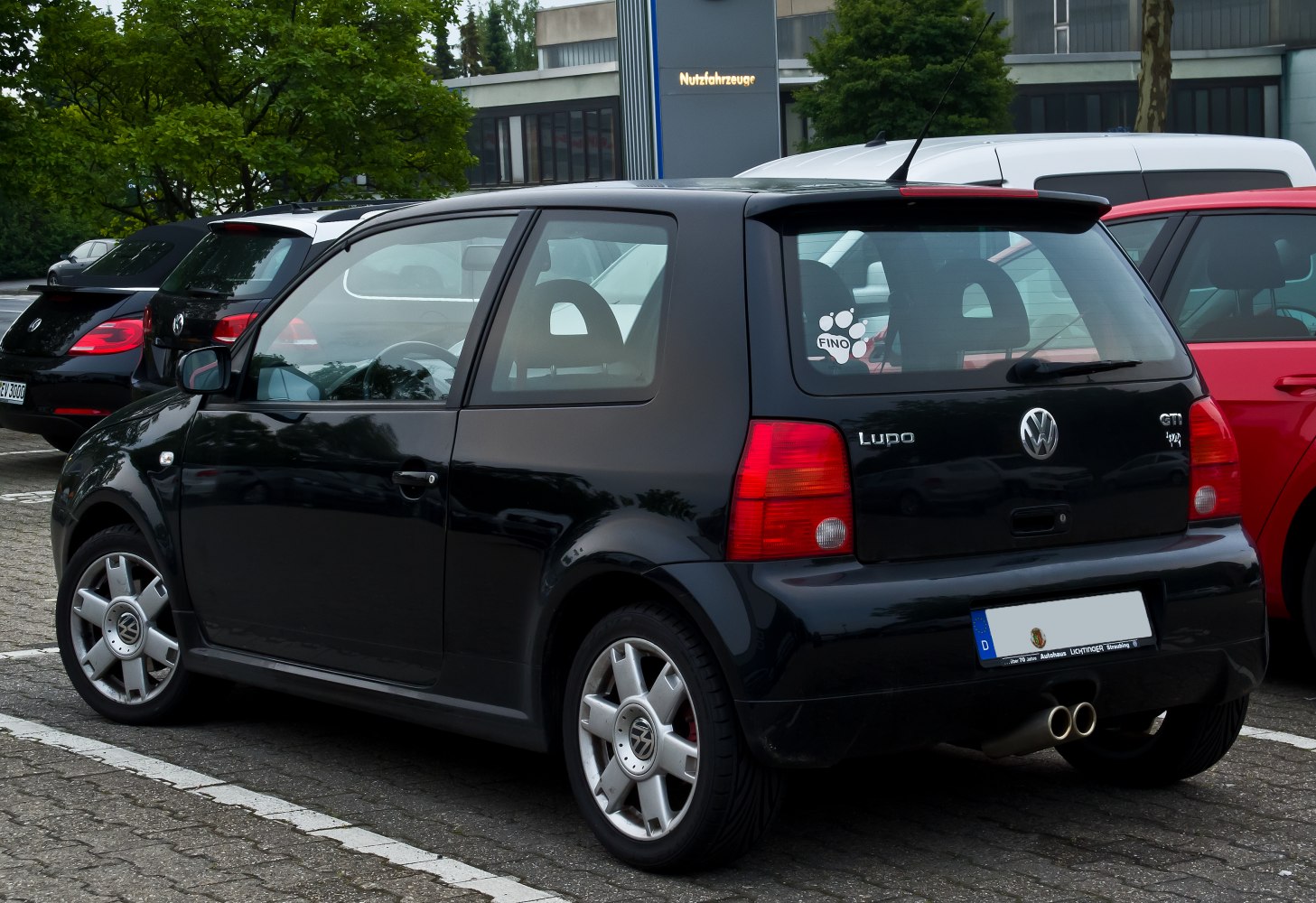Rear view of a compact hatchback with dual exhaust and spoiler