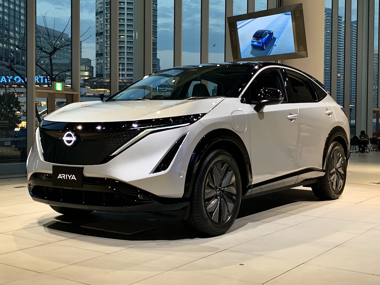 Front and side view of electric SUV with distinctive lighting and aerodynamic shape