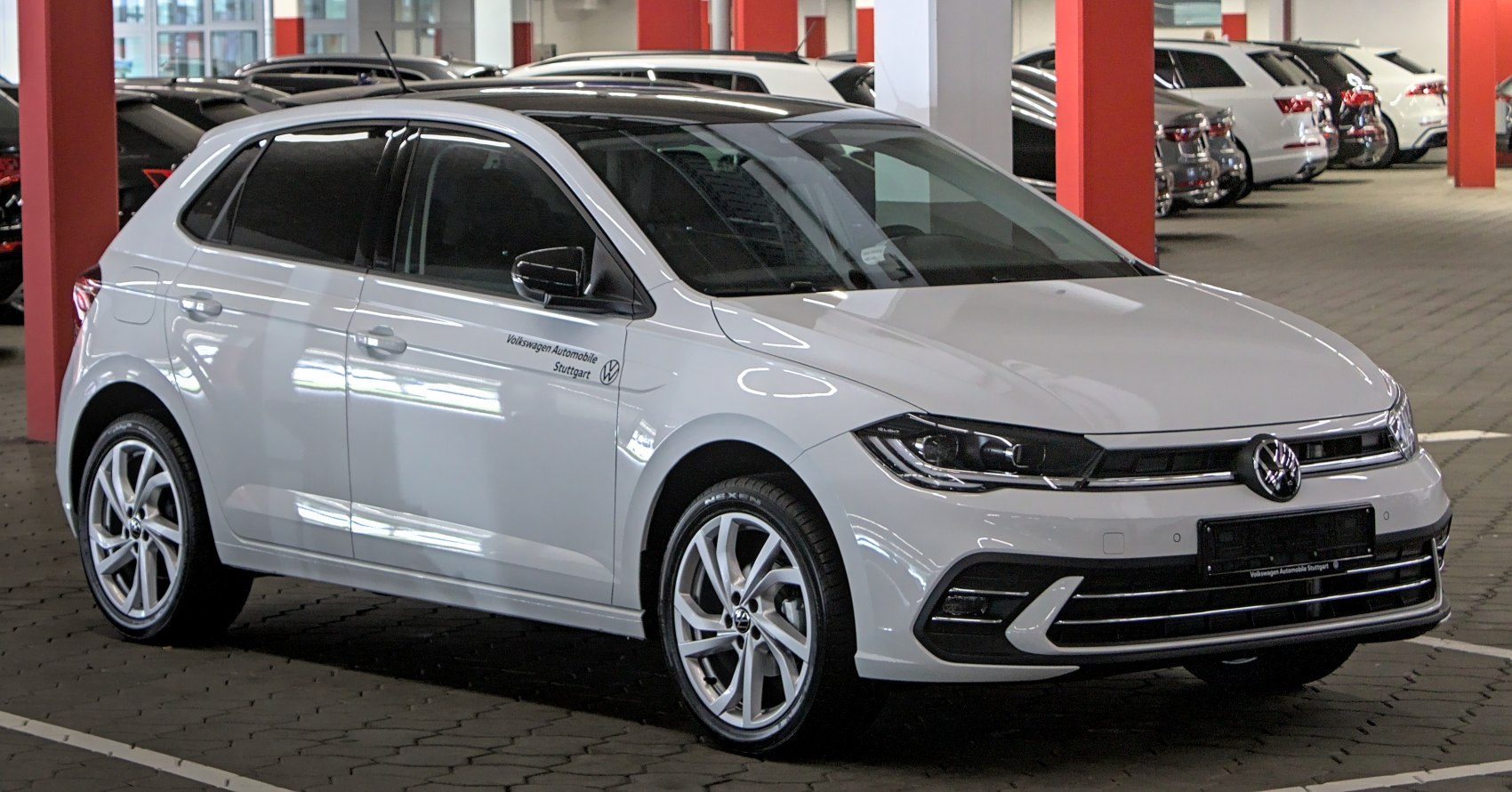 White five-door hatchback with LED headlights and alloy wheels in indoor parking