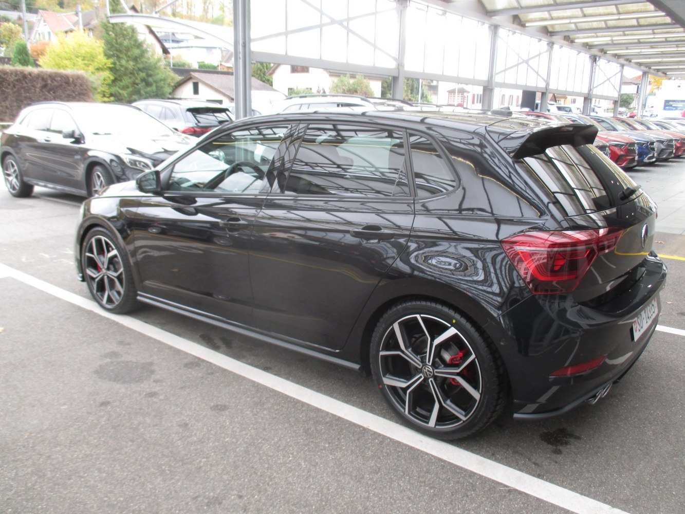 Black hatchback with sporty alloy wheels and rear spoiler