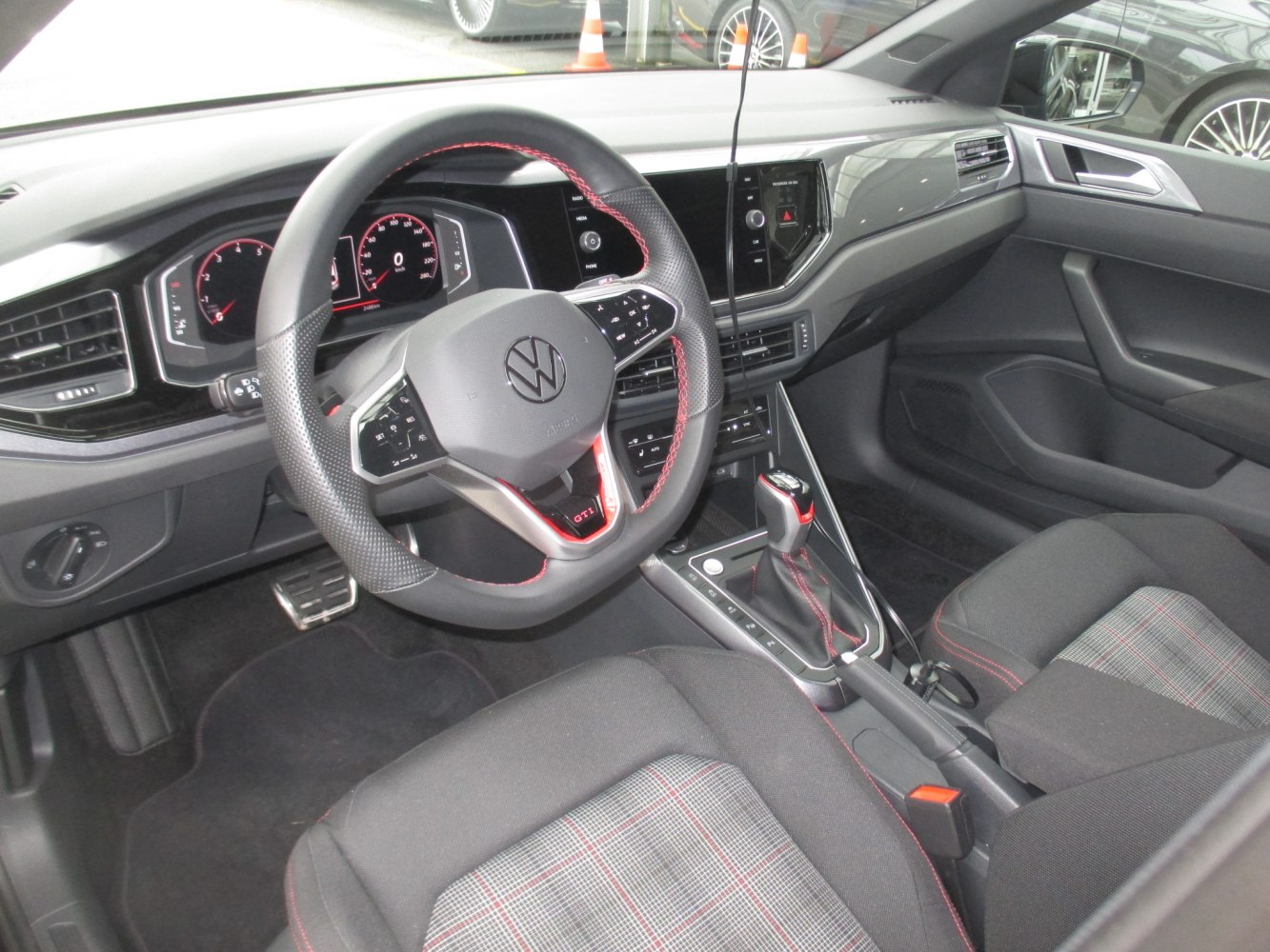 GTI styled steering wheel and digital dashboard in a modern car interior