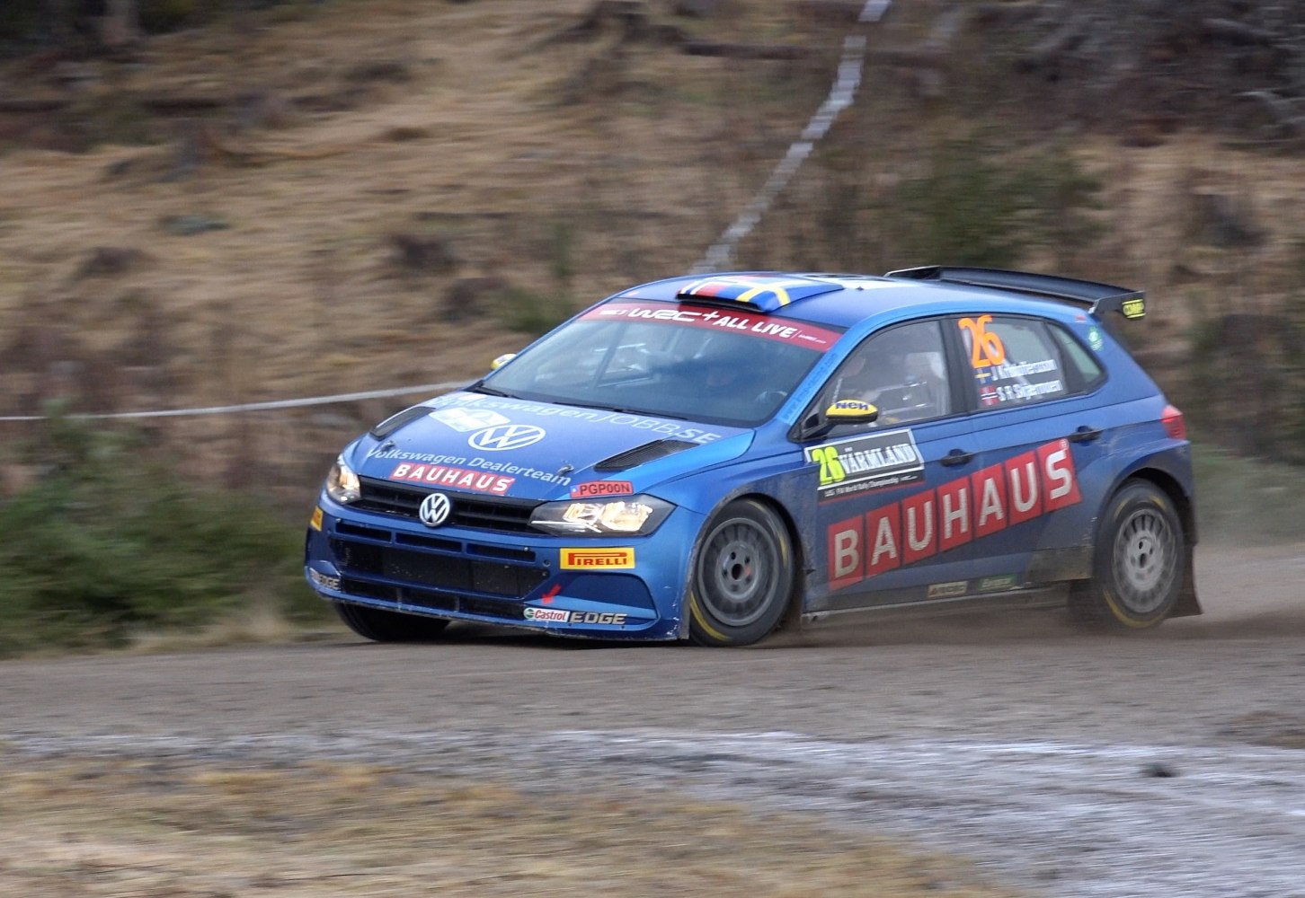 Blue rally hatchback with rear spoiler and racing decals