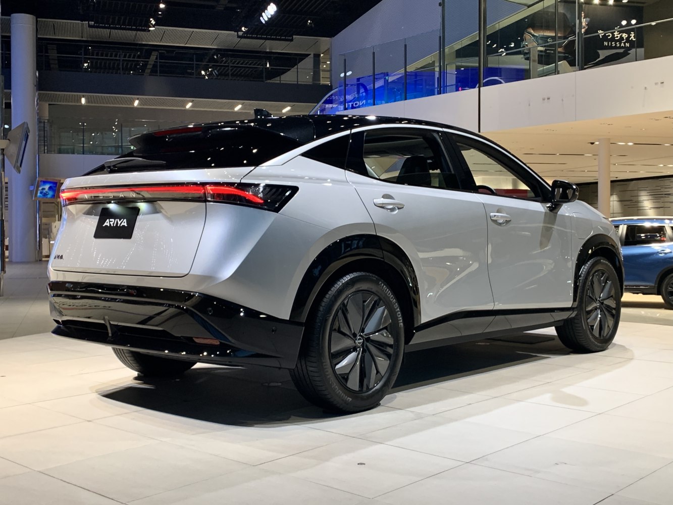Rear and side view of a modern electric SUV with aerodynamic design and unique wheels