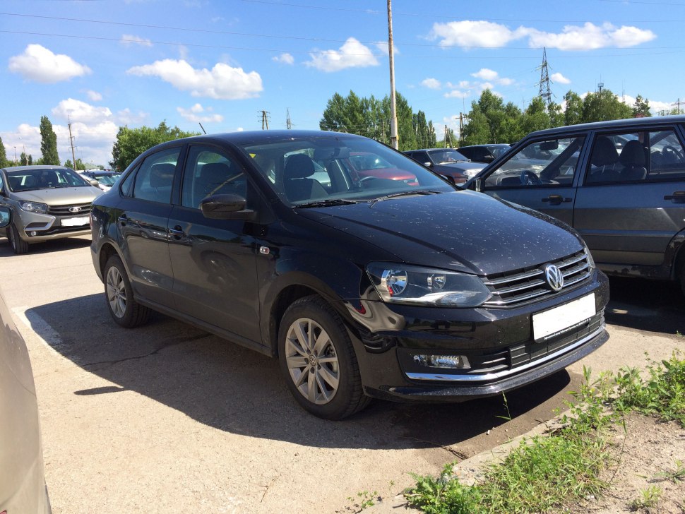 Front and side view of a black sedan with modern headlights and alloy wheels