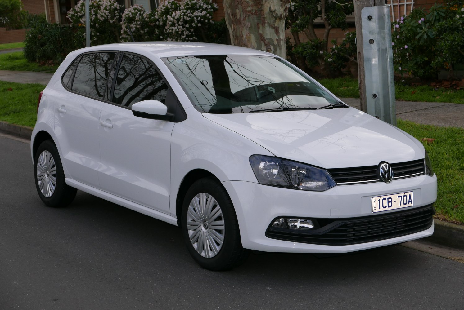 White compact hatchback with facelift front headlights and grille