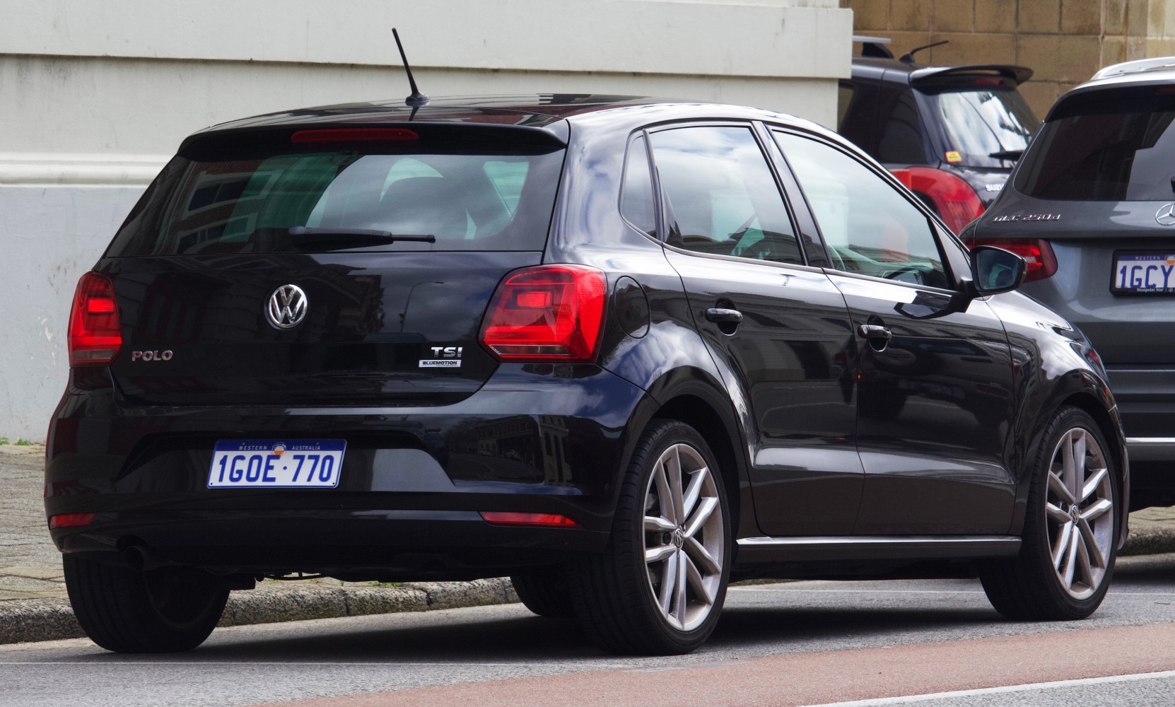 Black hatchback rear with distinctive taillights and alloy wheels