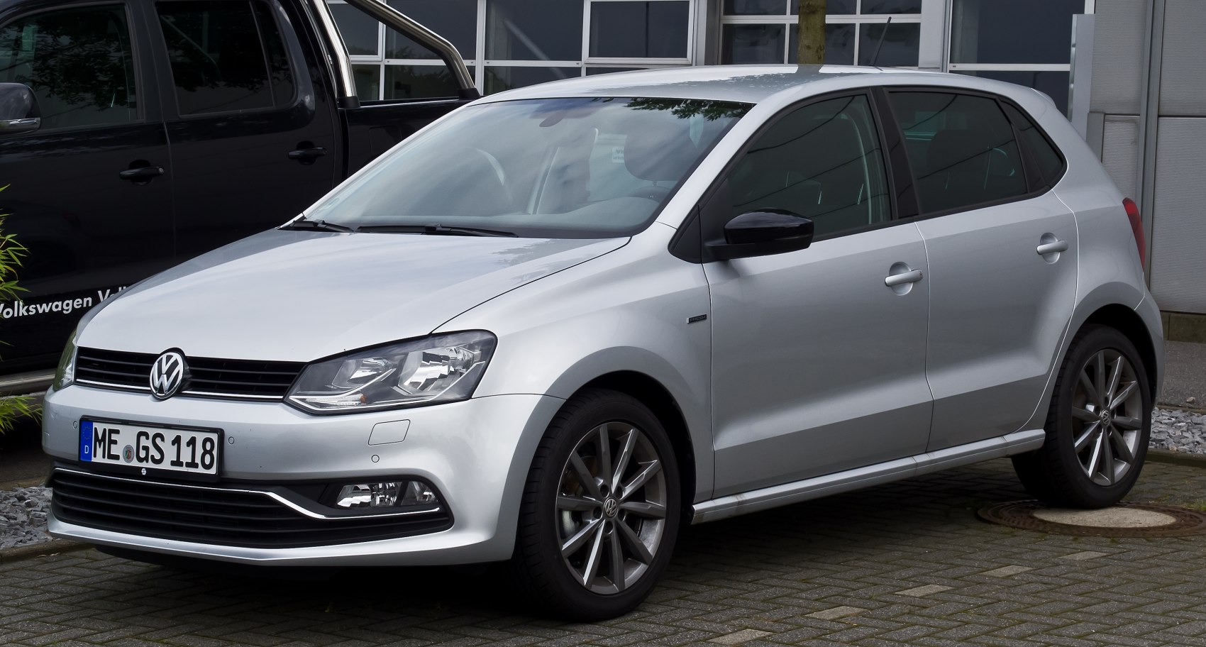 Silver hatchback with front grille and alloy wheels