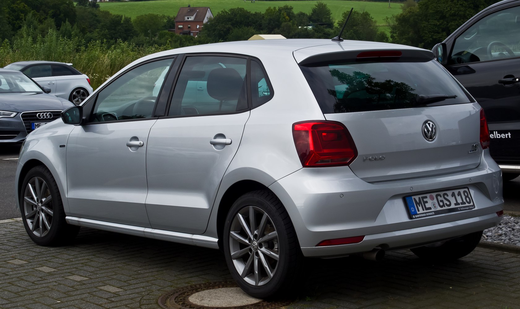 Rear side view of a 5-door hatchback with alloy wheels and tinted windows.