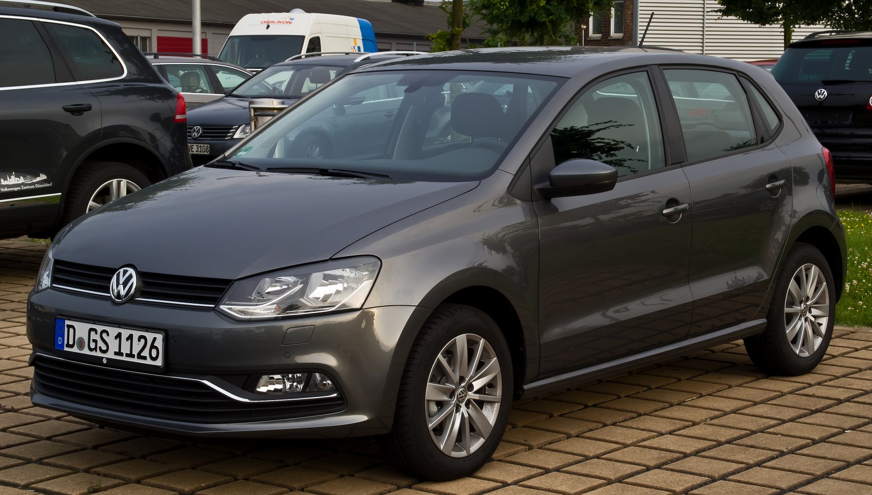 Front-side view showing headlights and alloy wheels of a hatchback.
