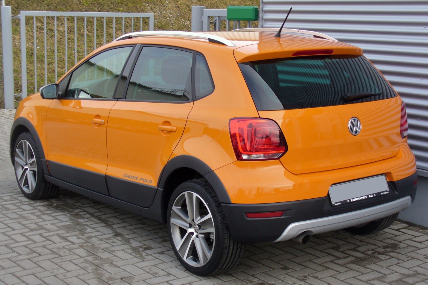 Rear and side view of a compact crossover with distinctive alloy wheels.