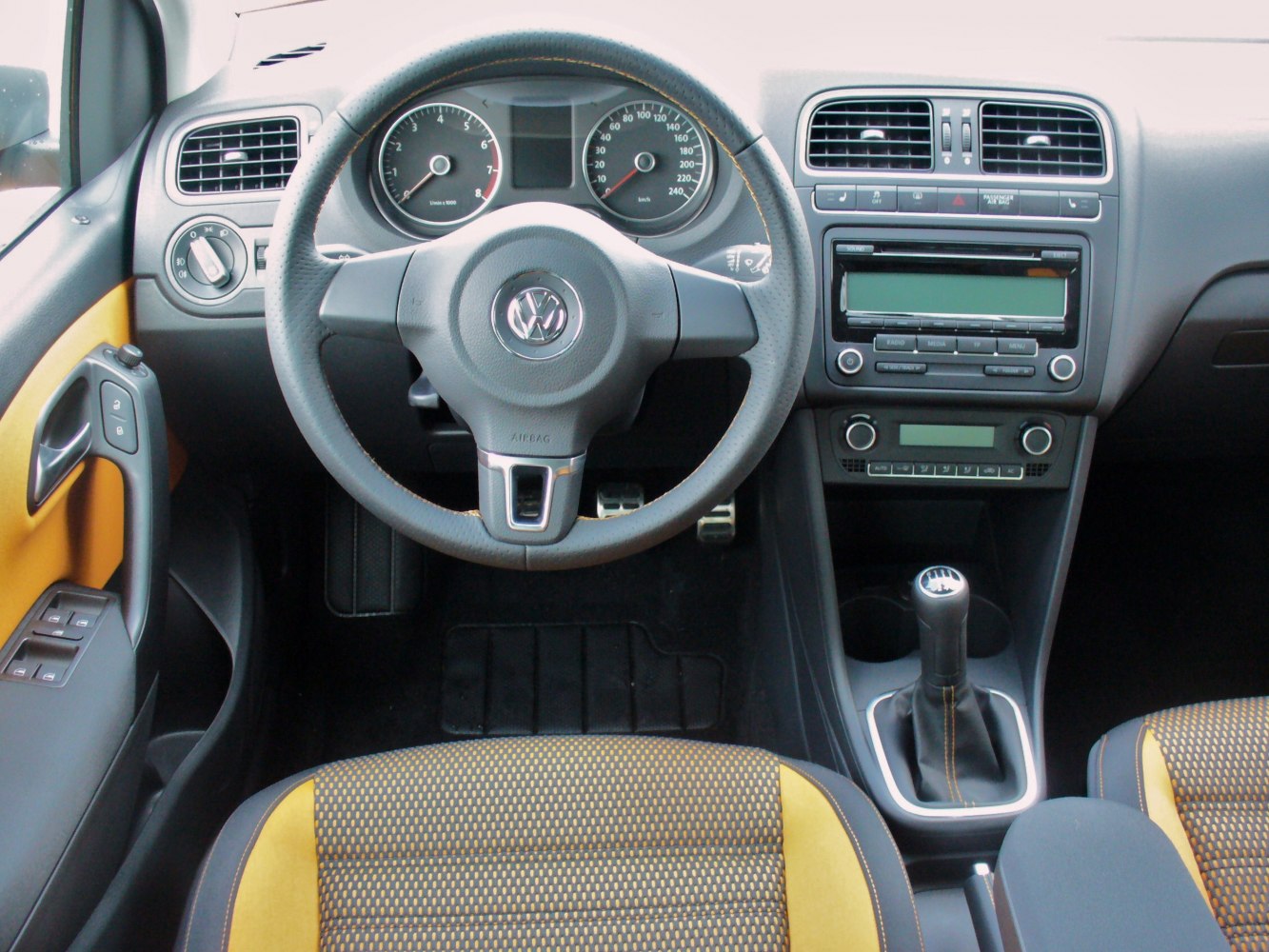 Dashboard, steering wheel, manual gear shift, and two-tone seats interior