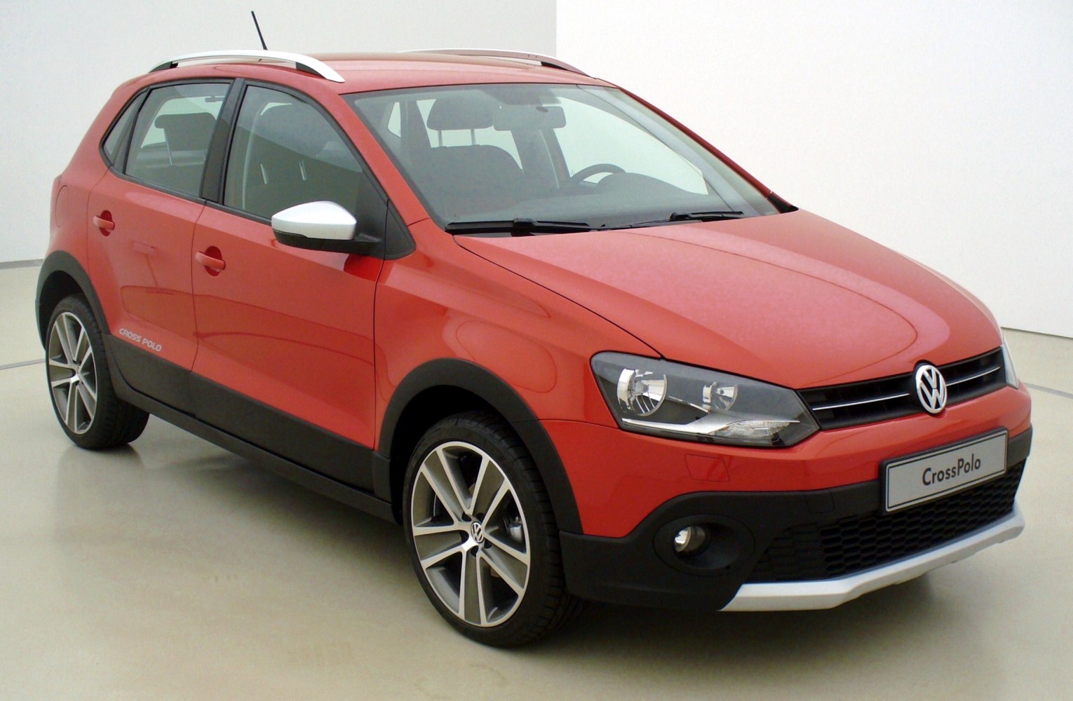 Red crossover hatchback with roof rails and alloy wheels