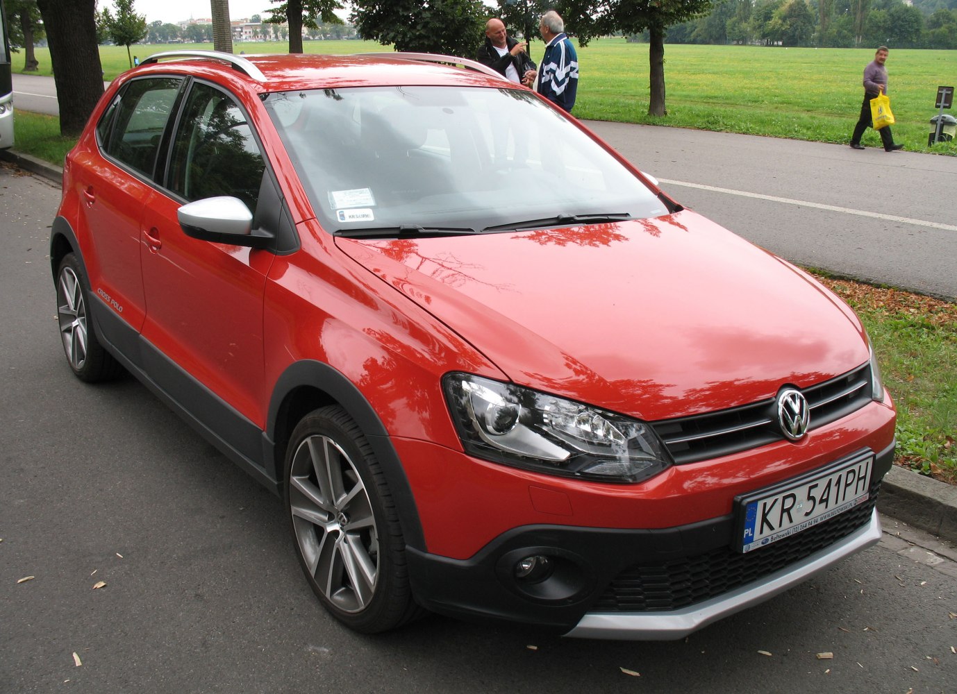 Red raised crossover hatchback with roof rails and alloy wheels