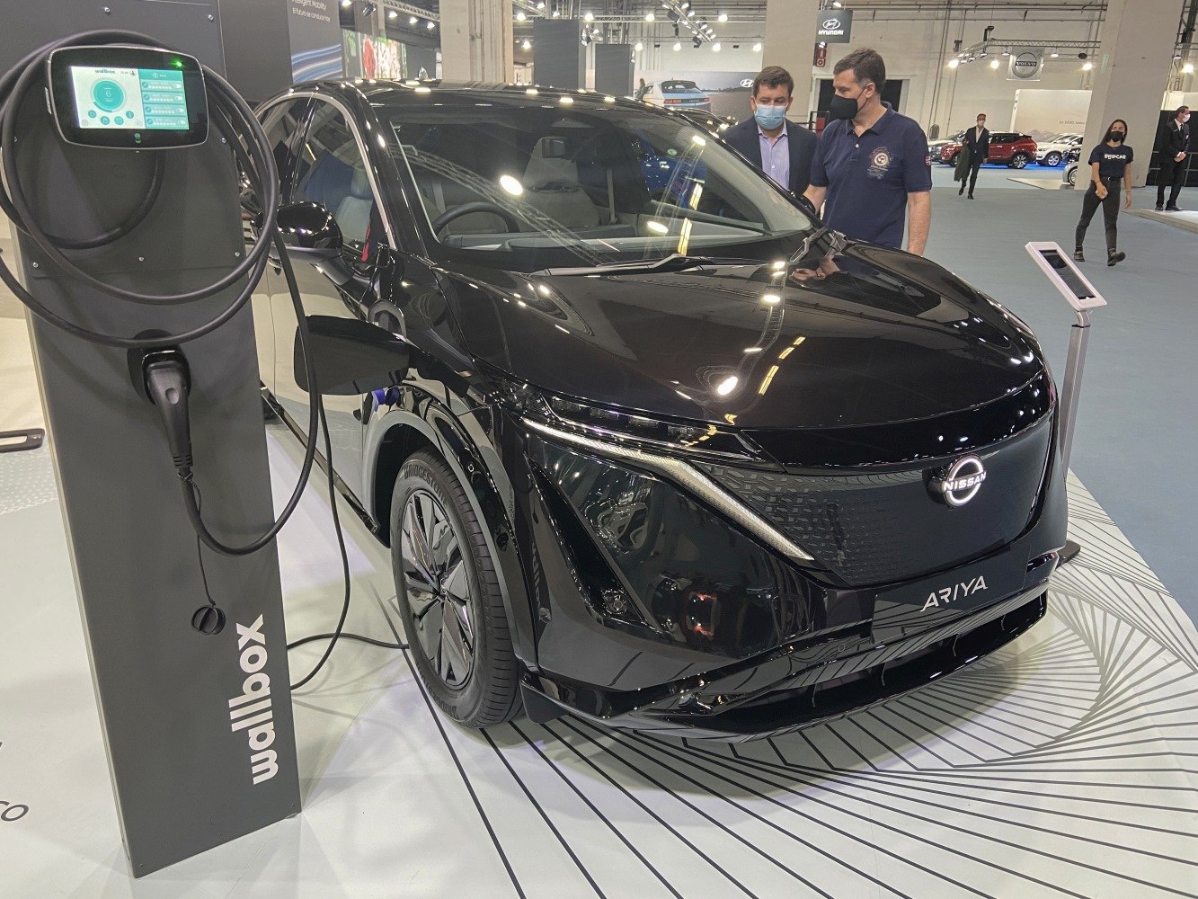 Electric SUV front and side view connected to a Wallbox charger