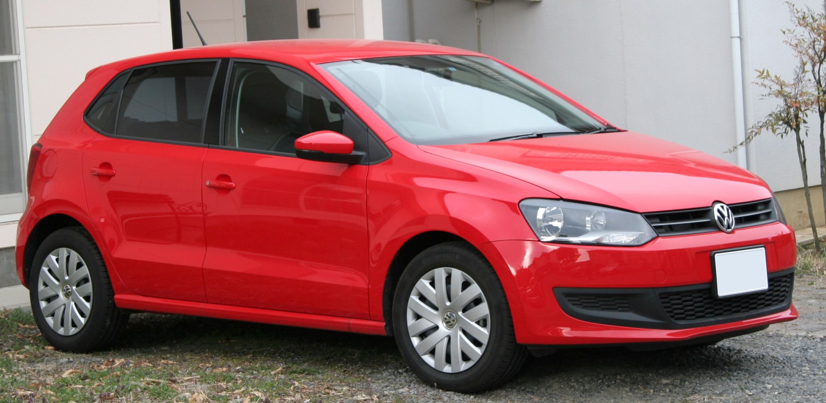 Red 5-door hatchback with angular headlights and modern compact design