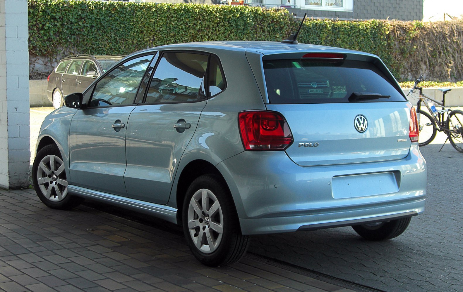 Rear side view of a 5-door hatchback with distinctive taillights and rear windshield.