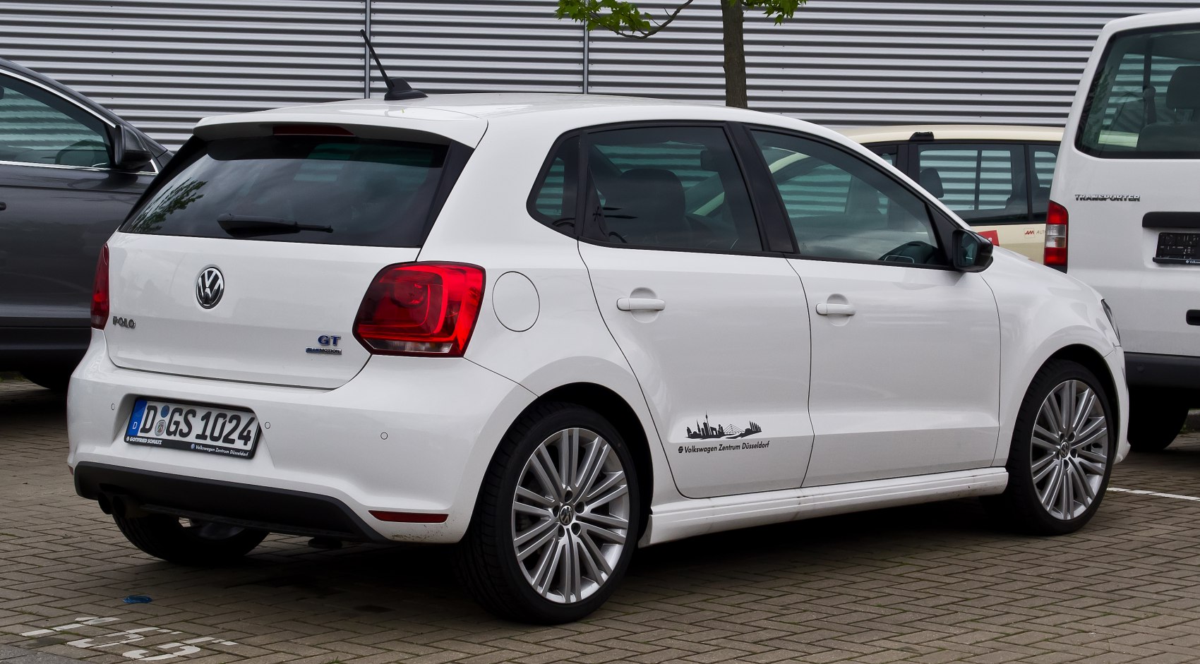 Rear side view of white 5-door hatchback with alloy wheels and distinctive taillights