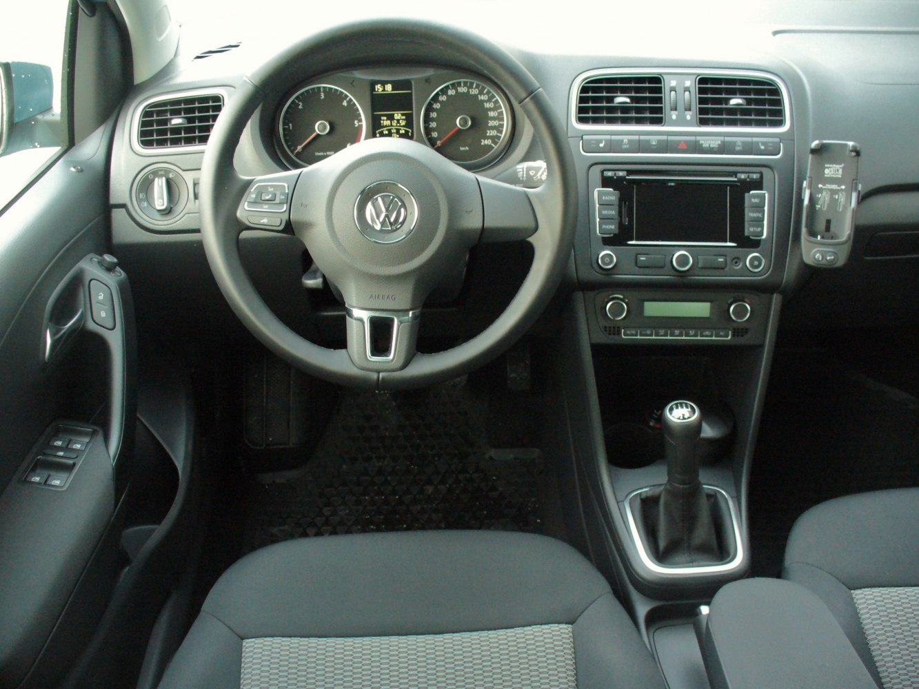 Car interior with dashboard, steering wheel, instrument cluster