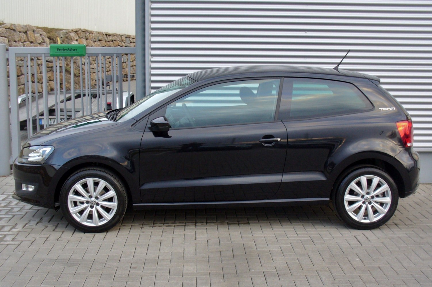 Black 3-door hatchback with alloy wheels and side mirror