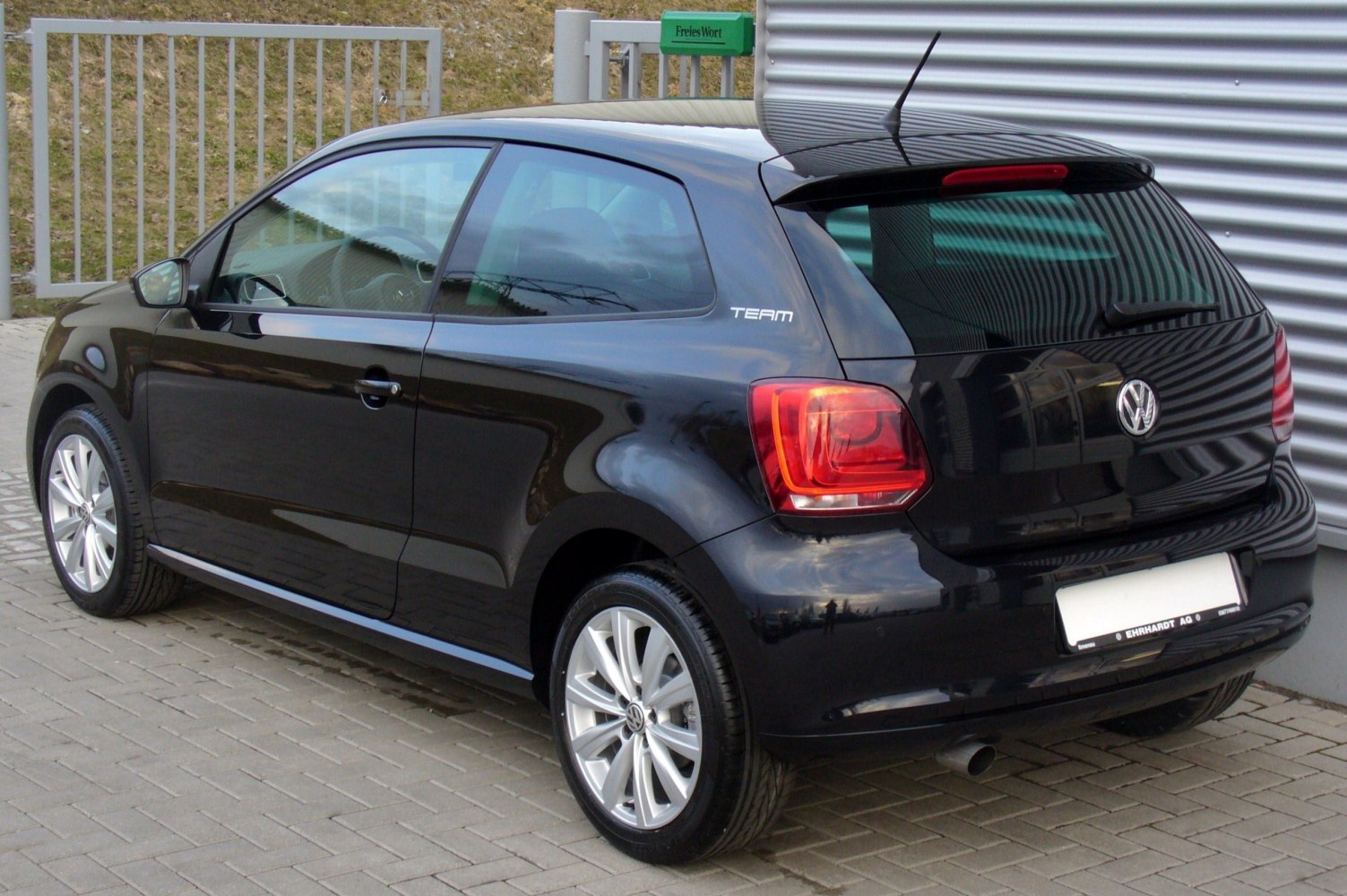 Rear side view of a black 3-door hatchback with distinctive taillights and alloy wheels