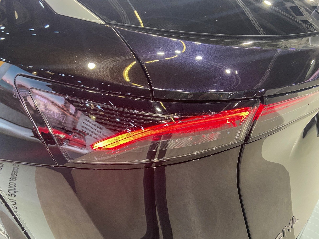 Close-up of a sleek rear LED tail light with sharp lines and reflective surfaces