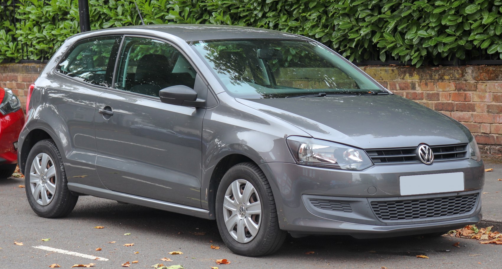 Front and side view of a 3-door hatchback exterior with headlights and grille