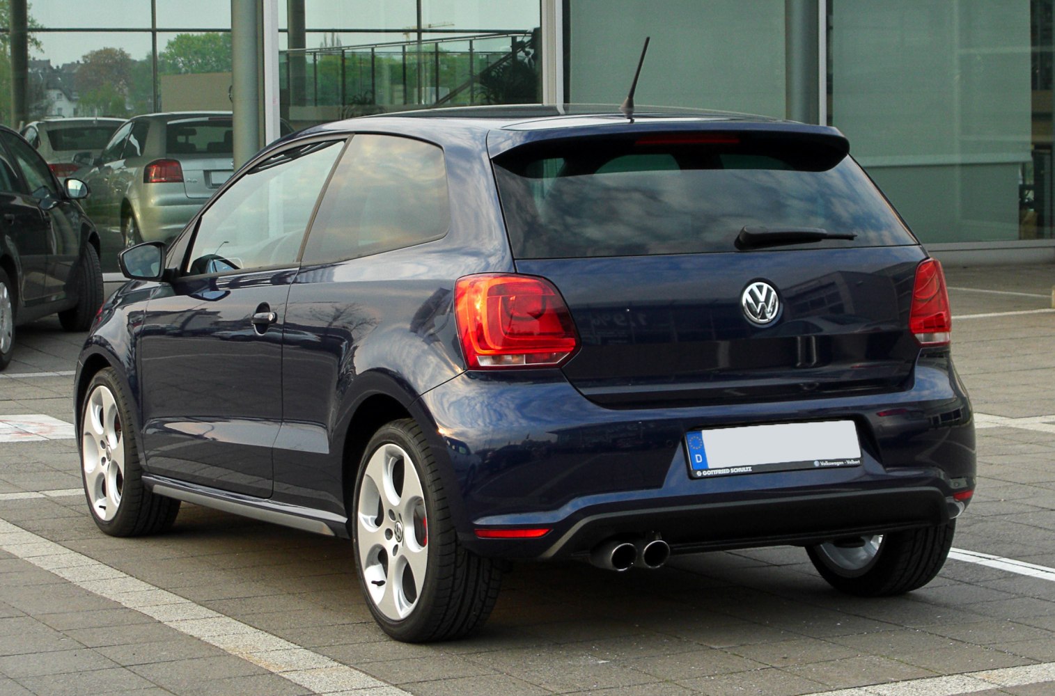 Rear view of a 3-door hatchback with dual exhaust and distinctive taillights