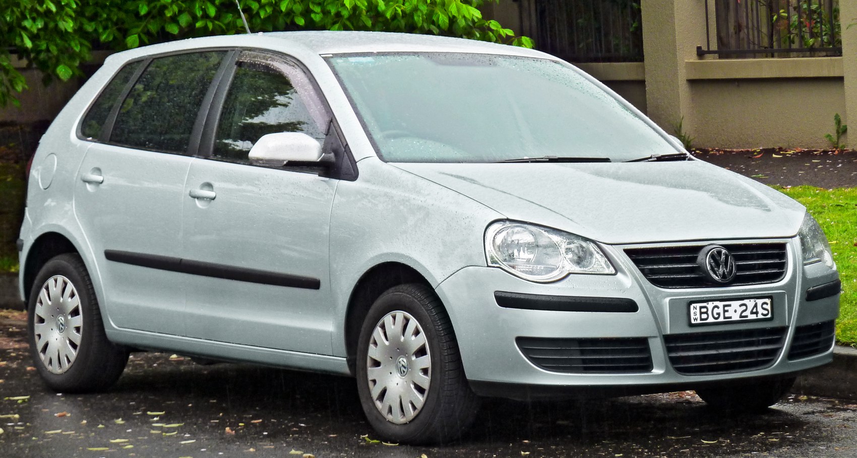 Front side view of a compact hatchback with distinct headlights and grille