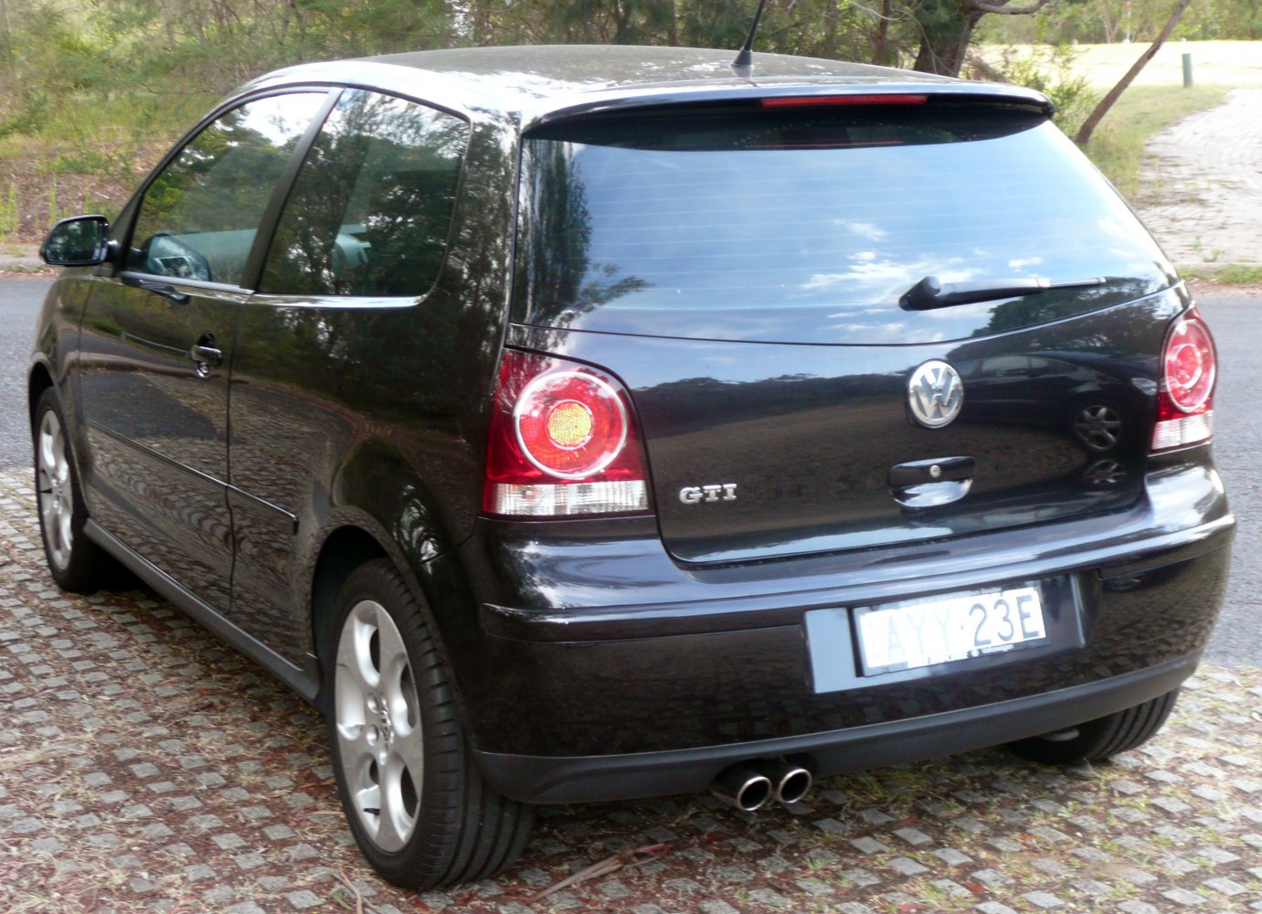 Rear hatchback with dual exhausts and round tail lights