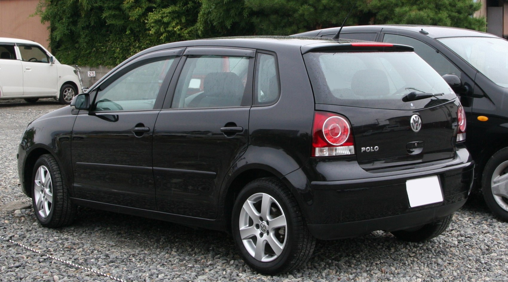 Rear-side view of black compact hatchback with alloy wheels and distinctive tail lights