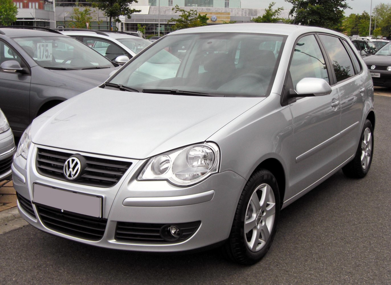 Front and side view of silver hatchback with updated headlights and grille