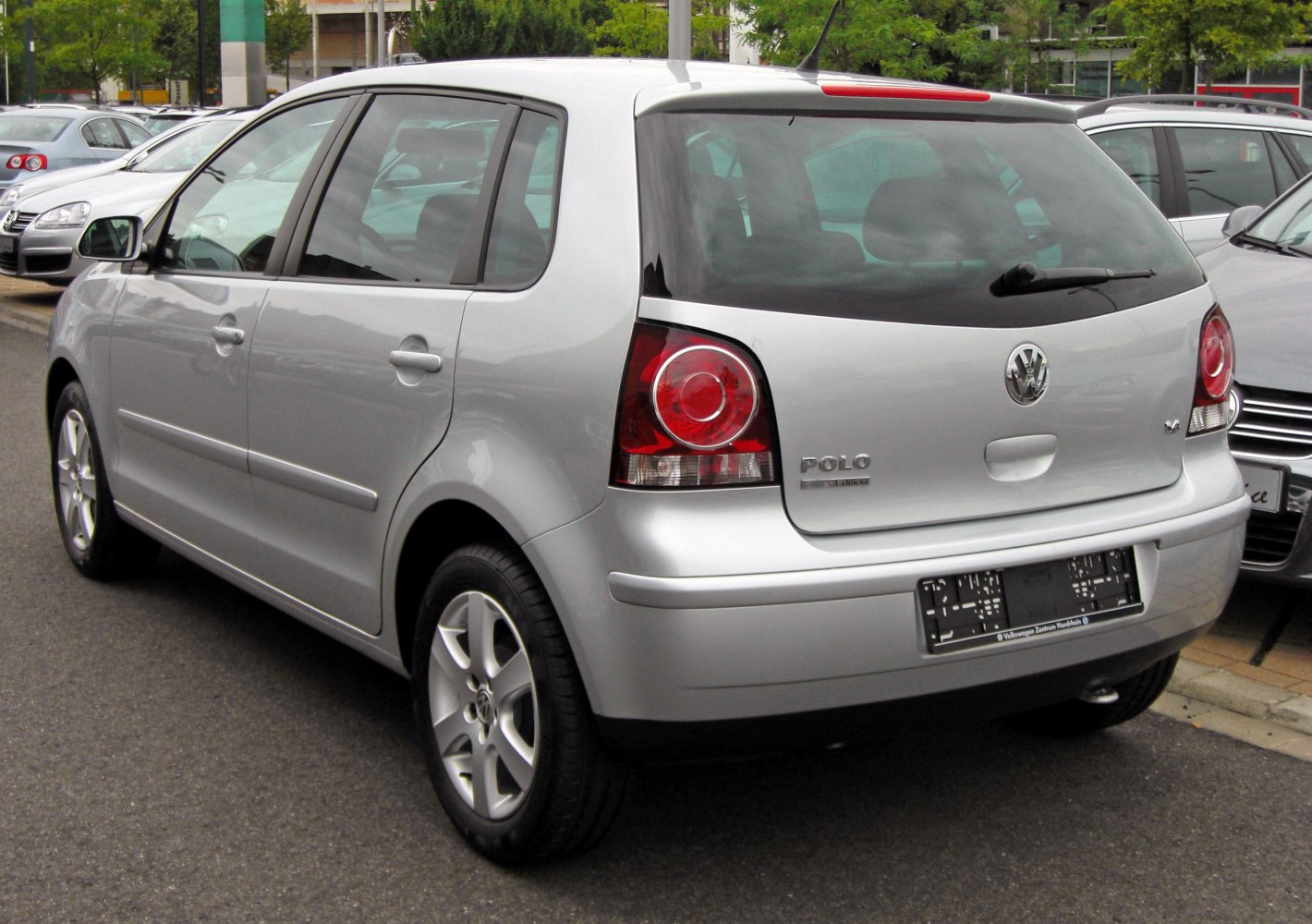 Silver five-door hatchback rear view with distinctive taillights and rear window wiper.